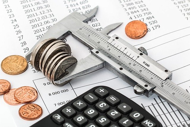 An image showing coins being measured with callipers.